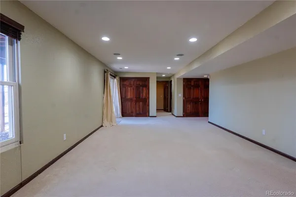 a view of an empty room with wooden door