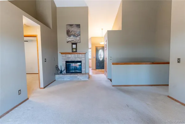 a view of an empty room with a fireplace