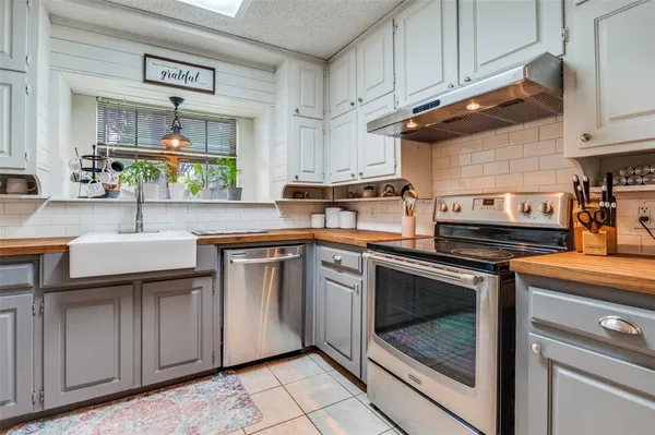 a kitchen with stainless steel appliances granite countertop a sink and a stove