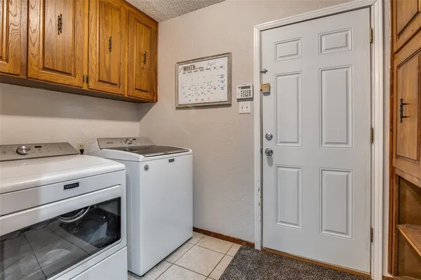 a view of a storage and utility room with washer and dryer