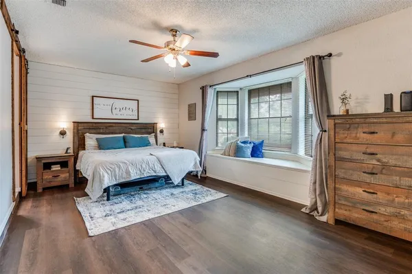 a bedroom with a large bed and a chandelier