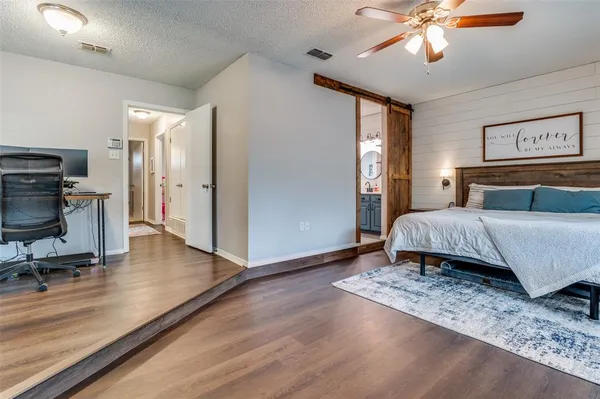 a bedroom with a bed and a chandelier