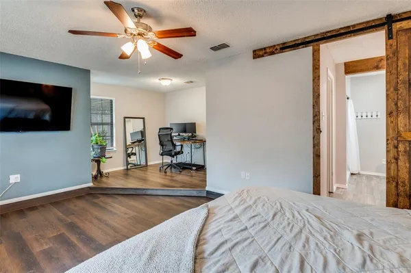 a bedroom with a bed and a flat screen tv