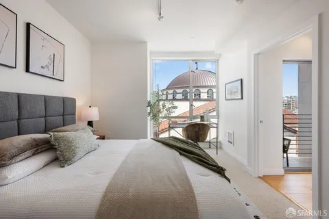 a bedroom with a bed and a potted plant