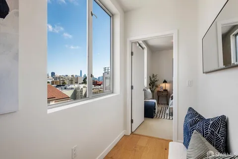 a bedroom with a bed and a painting on the wall