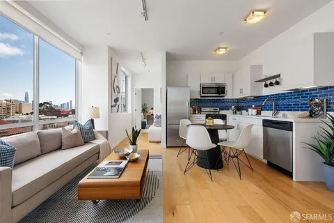 a living room with furniture kitchen view and a couch