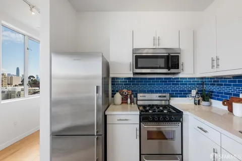 a kitchen with a refrigerator stove and microwave