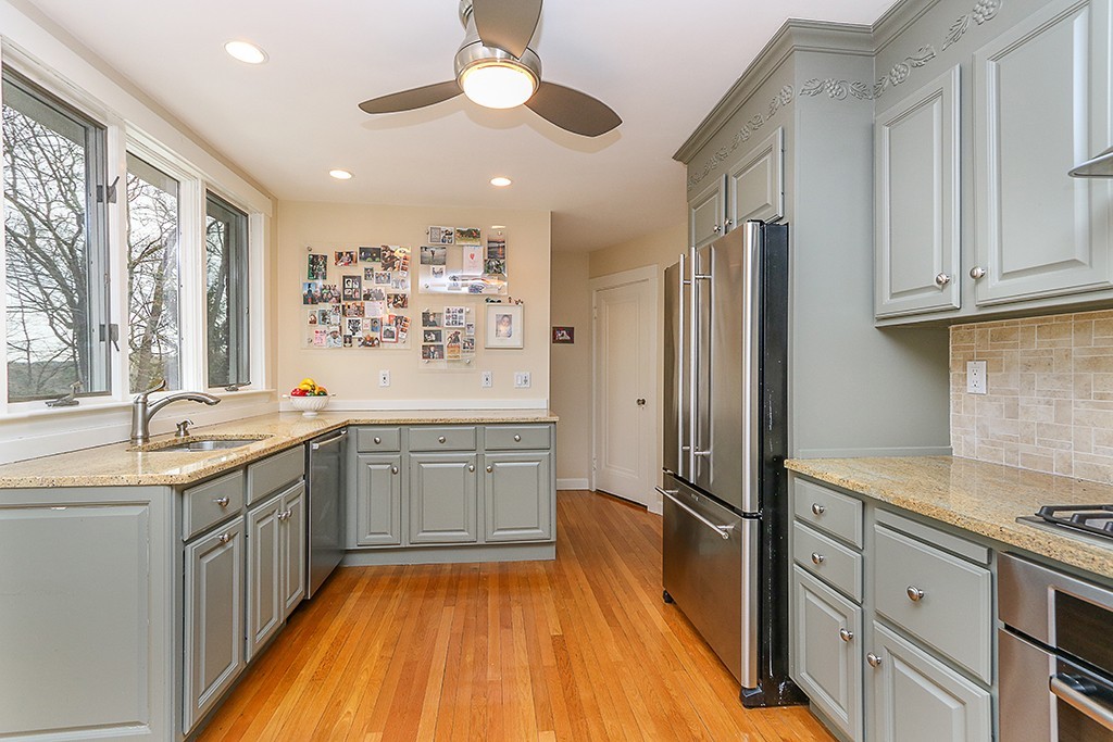 46 Greylock Road Newton, MA 02465 - Photo 13 of 25 a kitchen with stainless steel appliances granite countertop a sink stove and refrigerator