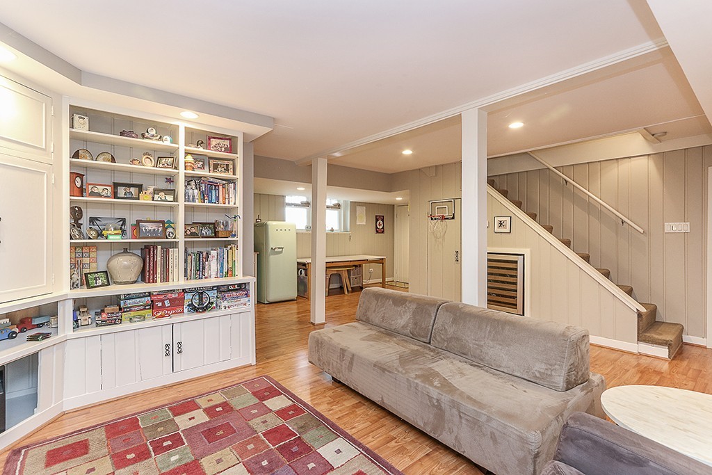 46 Greylock Road Newton, MA 02465 - Photo 21 of 25 a living room with furniture and a book shelf