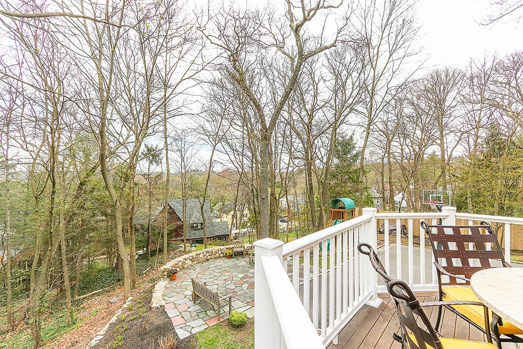 46 Greylock Road Newton, MA 02465 - Photo 23 of 25 a view of a roof deck with couches and wooden fence
