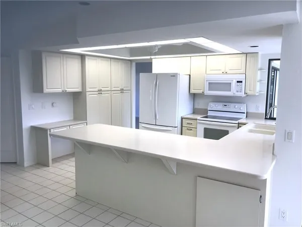 a kitchen with stainless steel appliances a sink and a refrigerator