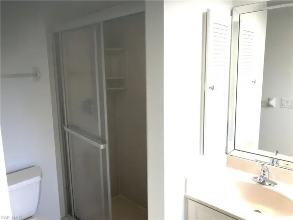 a bathroom with a bathtub sink and mirror