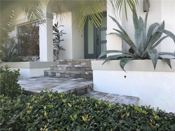 a view of a house with a sink and potted plants
