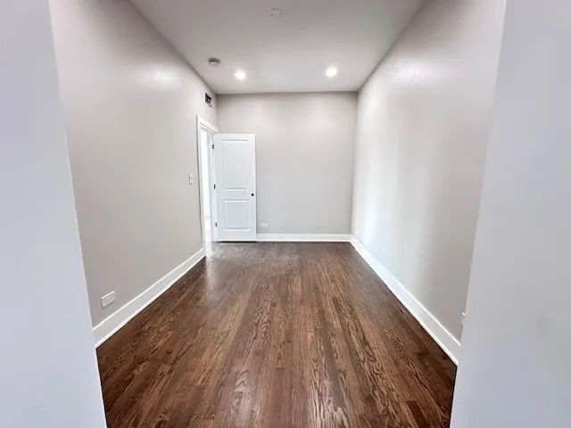 a view of hallway with wooden floor