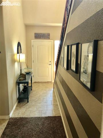 7888 Calabash Road Colorado Springs, CO 80908 - Photo 9 of 25 Entry Hall to Garage, Power Room, and Up Stairs