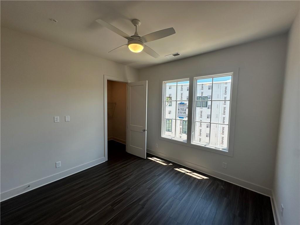 962 Bibb Street Northwest, Unit 6 Atlanta, GA 30318 - Photo 9 of 14 an empty room with wooden floor and windows