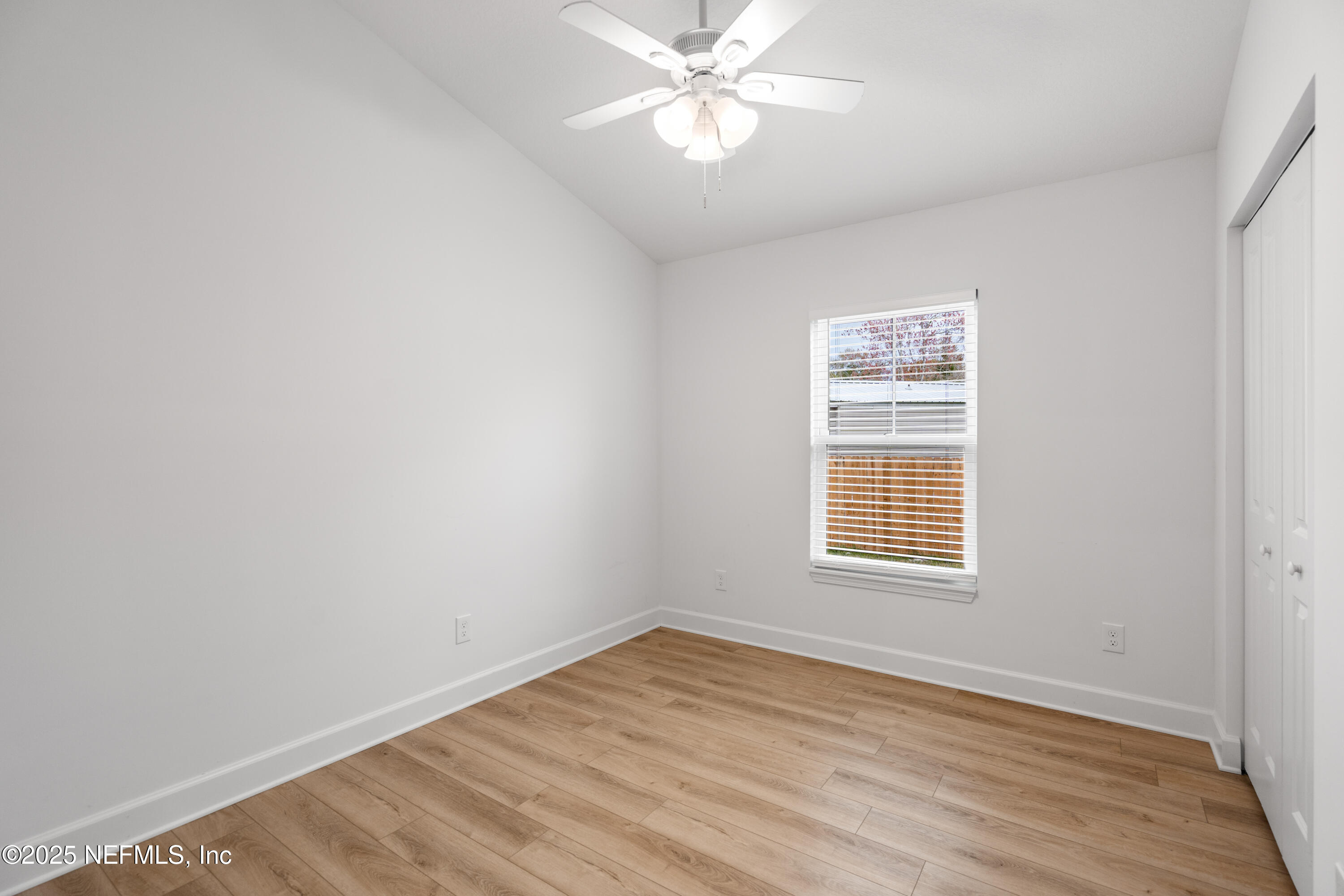 4532 Fourth Avenue St. Augustine, FL 32095 - Photo 12 of 24 a view of an empty room with wooden floor and a window