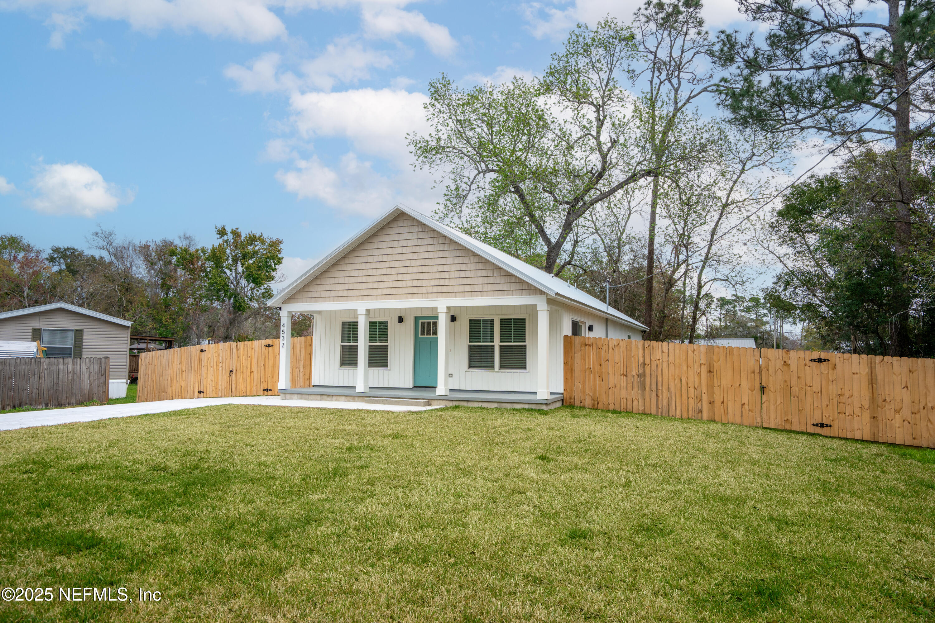 4532 Fourth Avenue St. Augustine, FL 32095 - Photo 2 of 24 a front view of house with yard and trees in the background