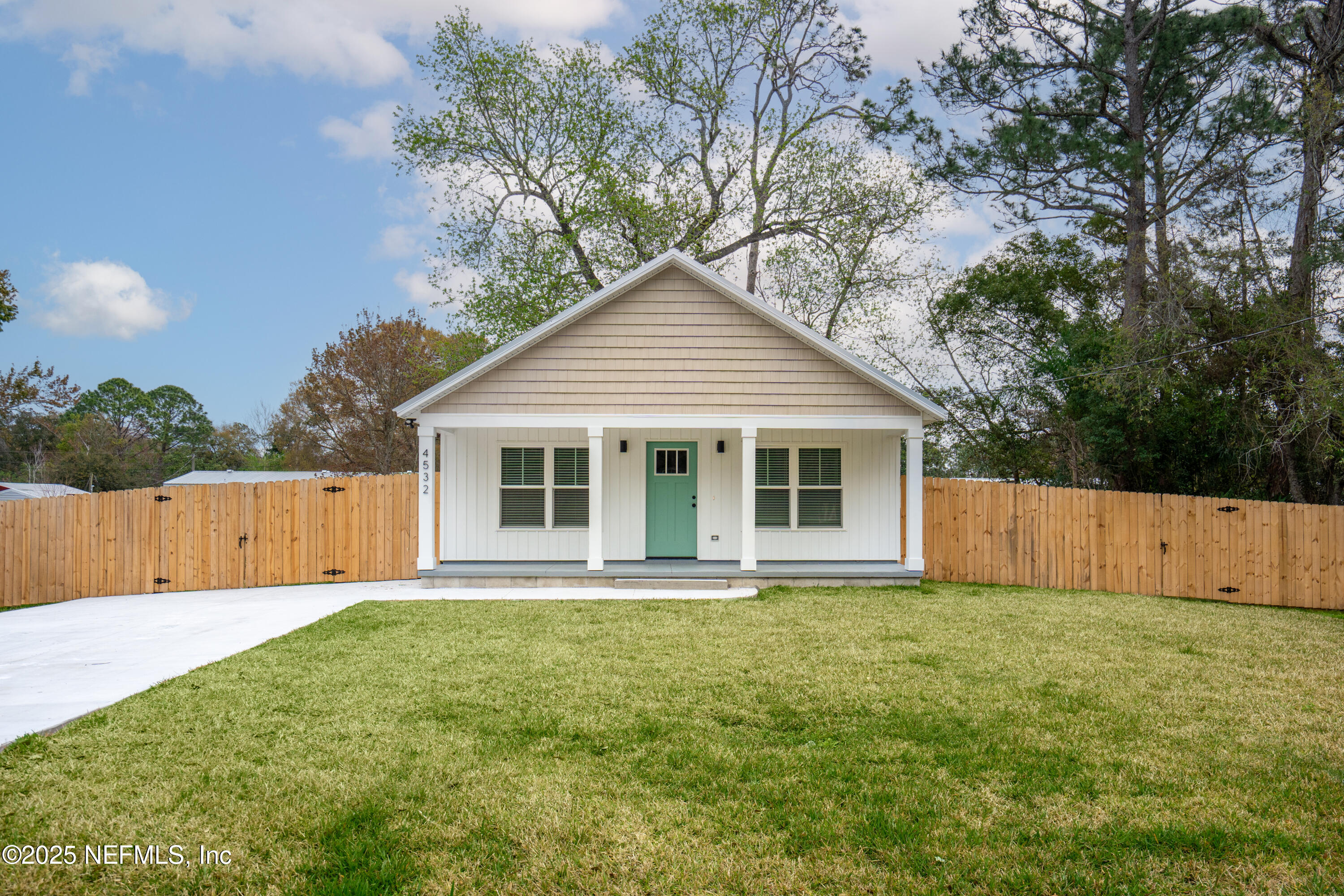 4532 Fourth Avenue St. Augustine, FL 32095 - Photo 3 of 24 a front view of house with yard and trees in the background