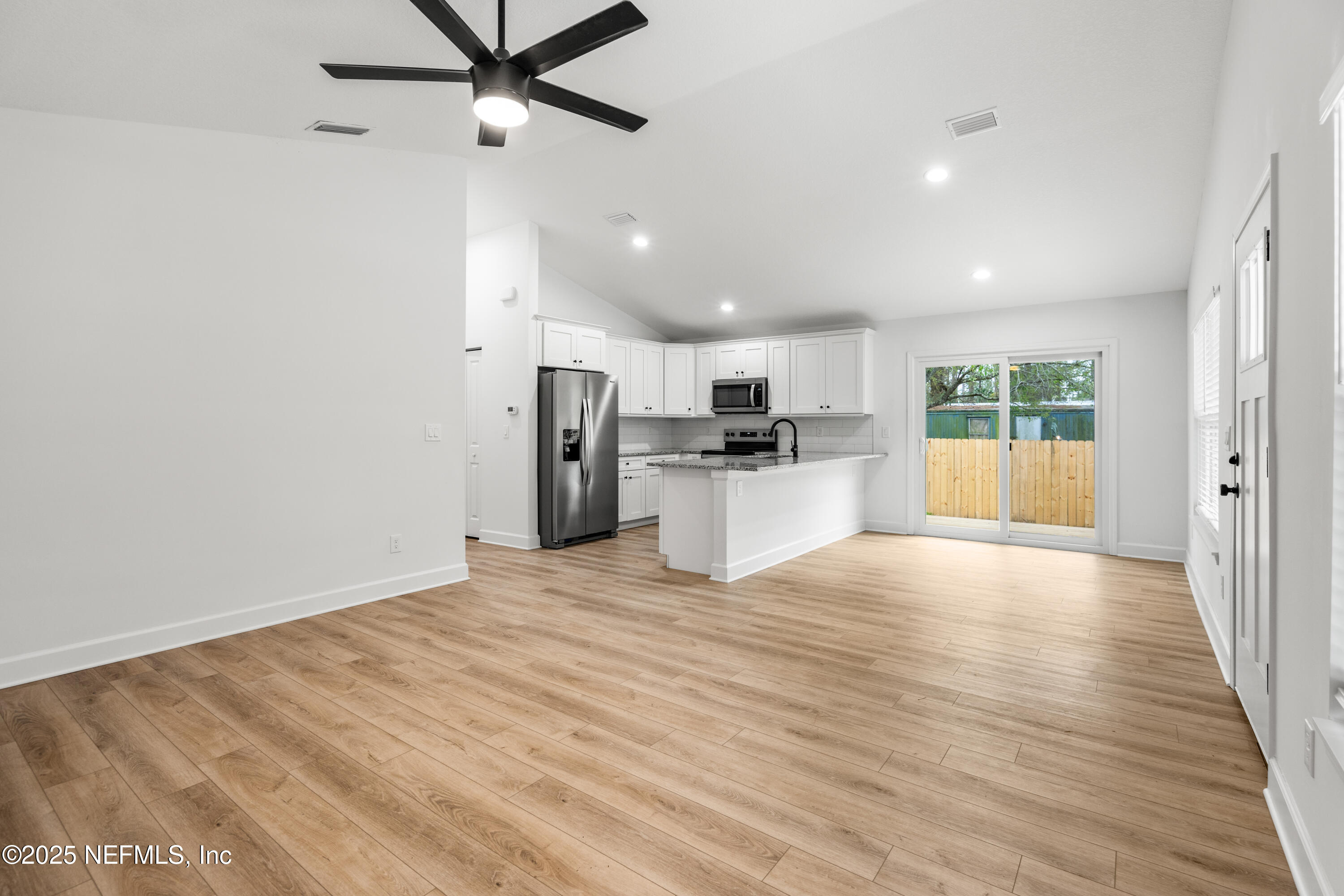 4532 Fourth Avenue St. Augustine, FL 32095 - Photo 7 of 24 a view of a kitchen with a sink and a refrigerator