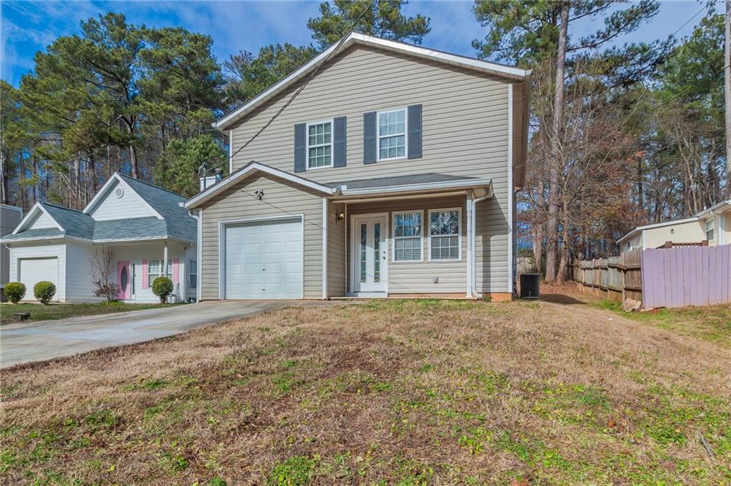 4612 Amy Road Snellville, GA 30039 - Photo 1 of 1 a front view of a house with a yard and garage