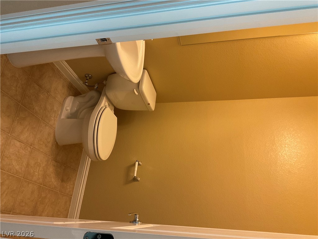 12 Jasmine Point Street Henderson, NV 89074 - Photo 14 of 15 A well-appointed bathroom with durable tiled flooring and a convenient toilet setup.