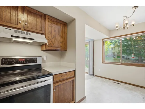 a kitchen with wooden cabinets and a stove top oven