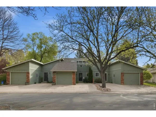 a house that has a tree in front of it