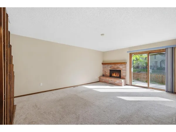 a view of empty room with a fireplace