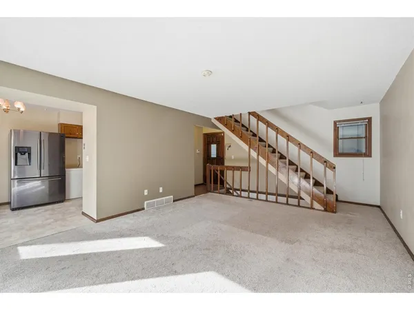 a view of an empty room with stairs
