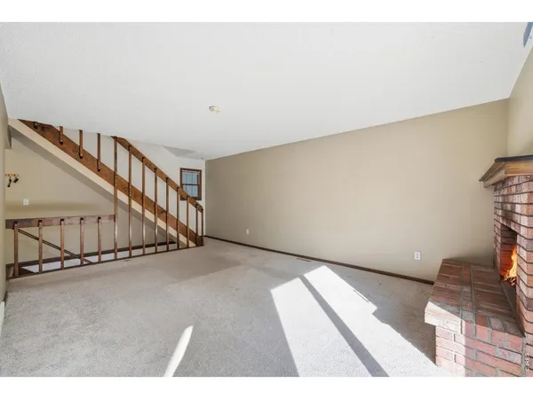 a view of an empty room with stairs
