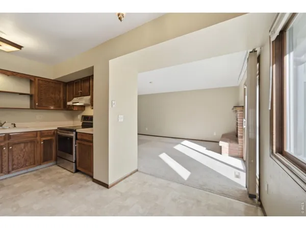 a kitchen with kitchen island a counter top space a stove and refrigerator