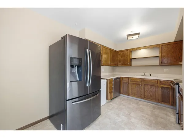a kitchen with stainless steel appliances a refrigerator and a sink