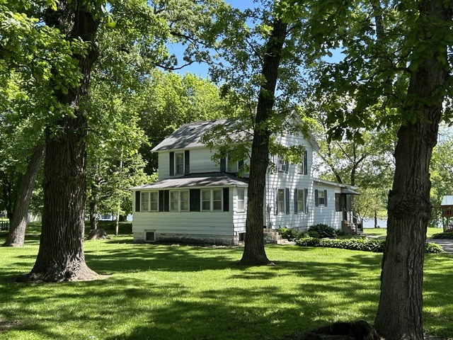 33709 West River Road Wilmington, IL 60481 - Photo 1 of 28 a view of a house with a backyard