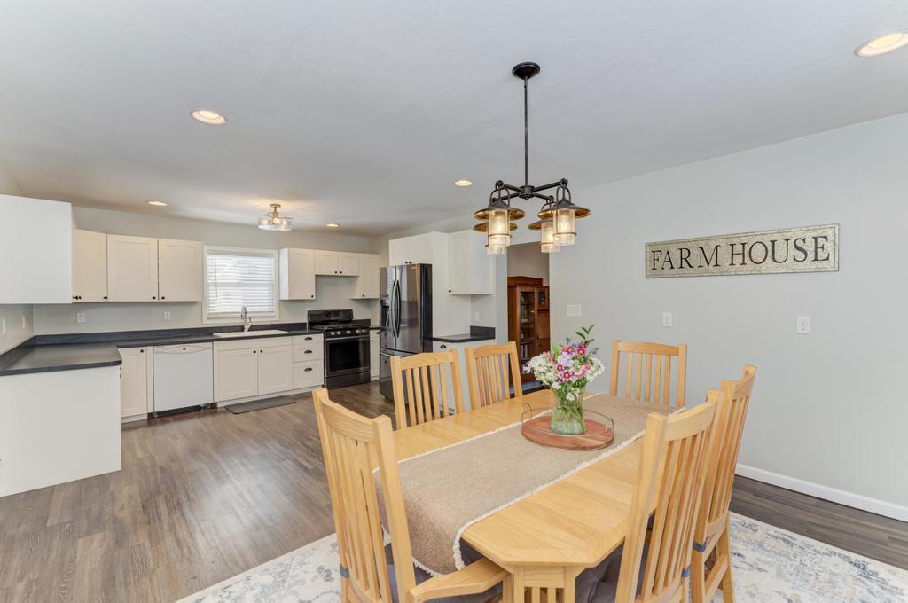33709 West River Road Wilmington, IL 60481 - Photo 11 of 28 a view of a dining room with furniture a chandelier and wooden floor