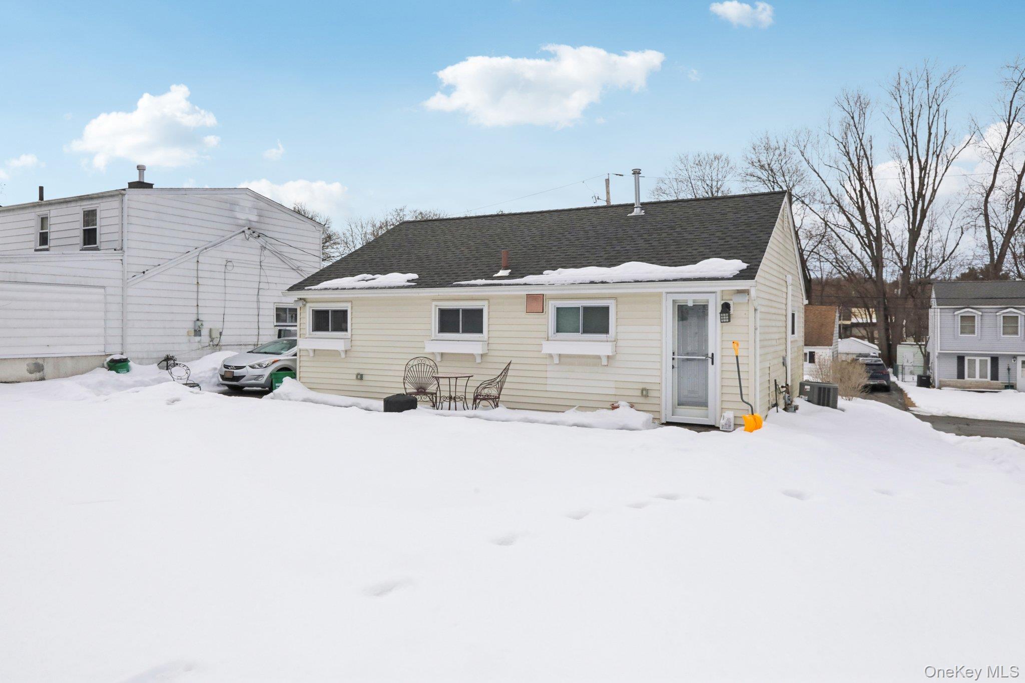 18 Lake Road Stony Point, NY 10980 - Photo 16 of 18 a view of a white house with a yard covered in snow