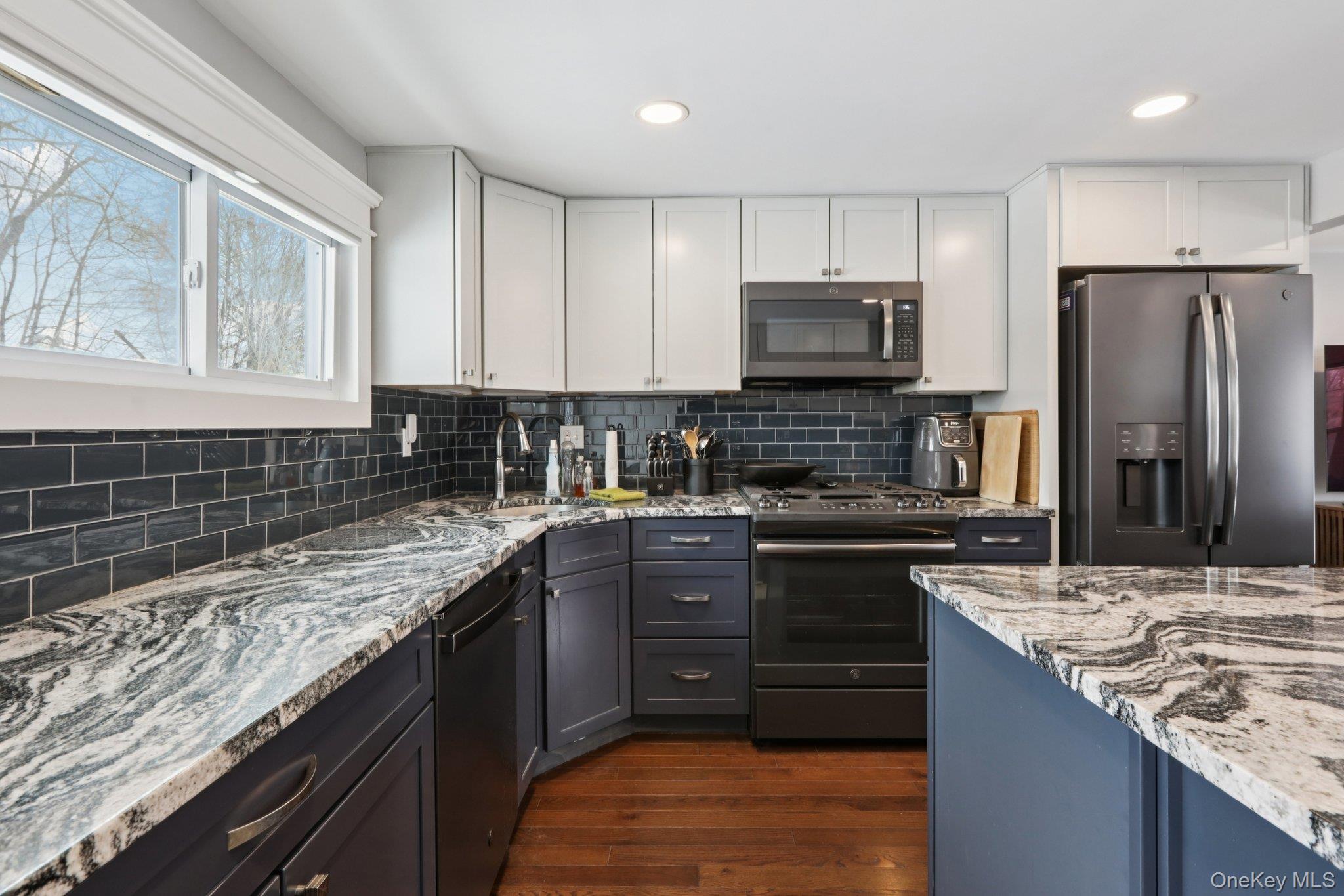 18 Lake Road Stony Point, NY 10980 - Photo 9 of 18 a kitchen with stainless steel appliances granite countertop a sink stove and refrigerator