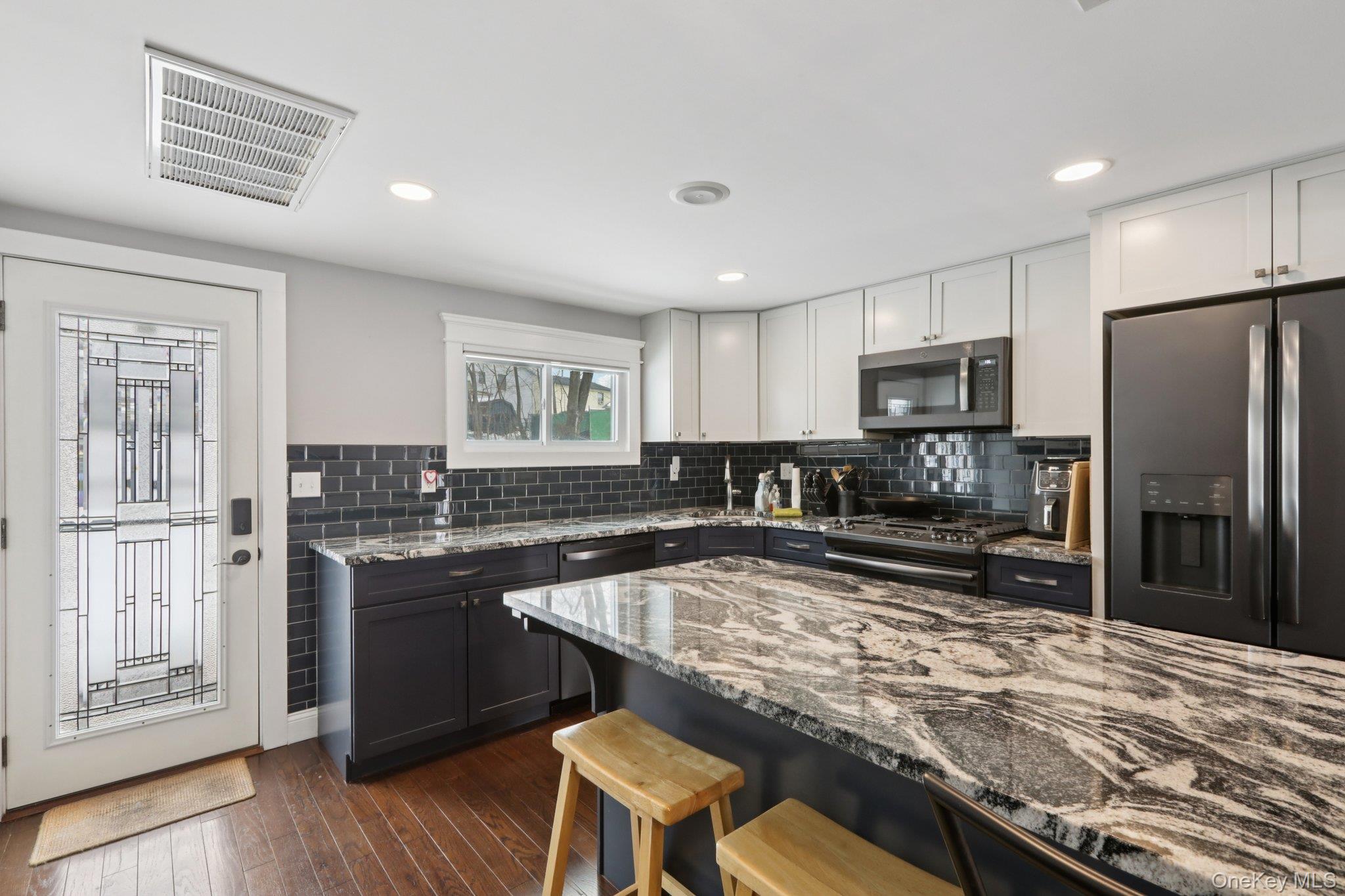 18 Lake Road Stony Point, NY 10980 - Photo 10 of 18 a kitchen with kitchen island granite countertop a stove sink cabinets and refrigerator