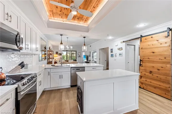 a kitchen with cabinets appliances and a window