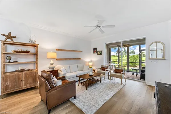 a living room with furniture wooden floor and a window