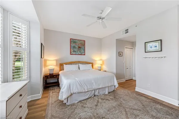 a bedroom with a large bed and a window