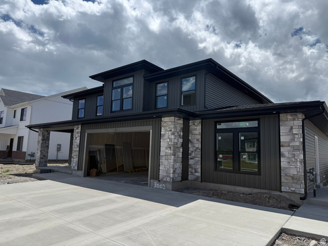 1008 West 3410 South Nibley, UT 84321 - Photo 2 of 26 Contemporary exterior featuring dark horizontal siding and stone veneer accents