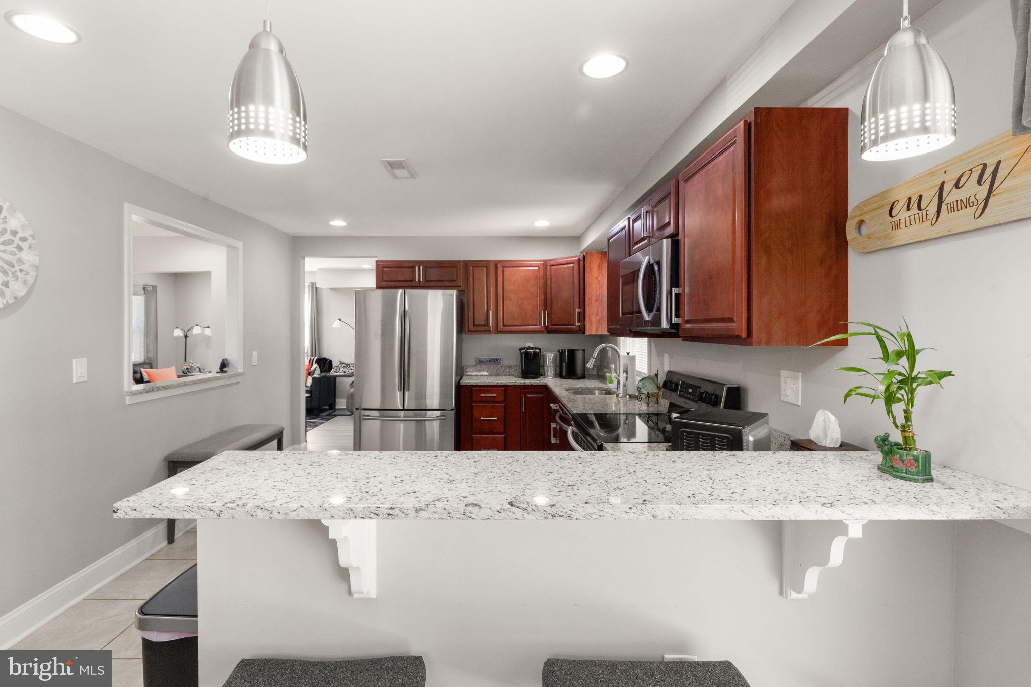 814 Foxwell Road Joppa, MD 21085 - Photo 7 of 21 a kitchen with stainless steel appliances granite countertop a sink refrigerator and microwave