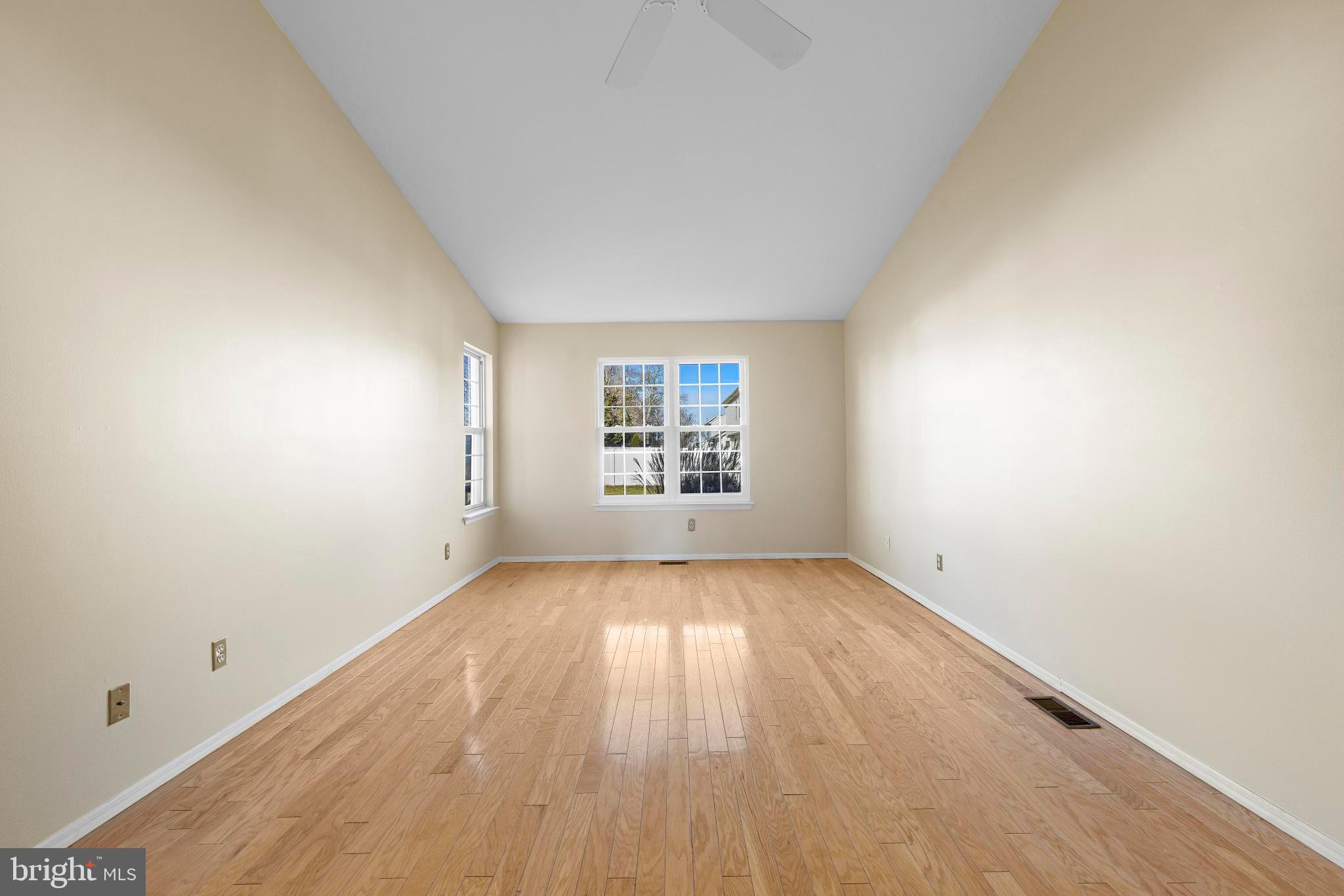 104 Greenwood Lake Road Little Egg Harbor, NJ 08087 - Photo 11 of 43 an empty room with wooden floor and windows