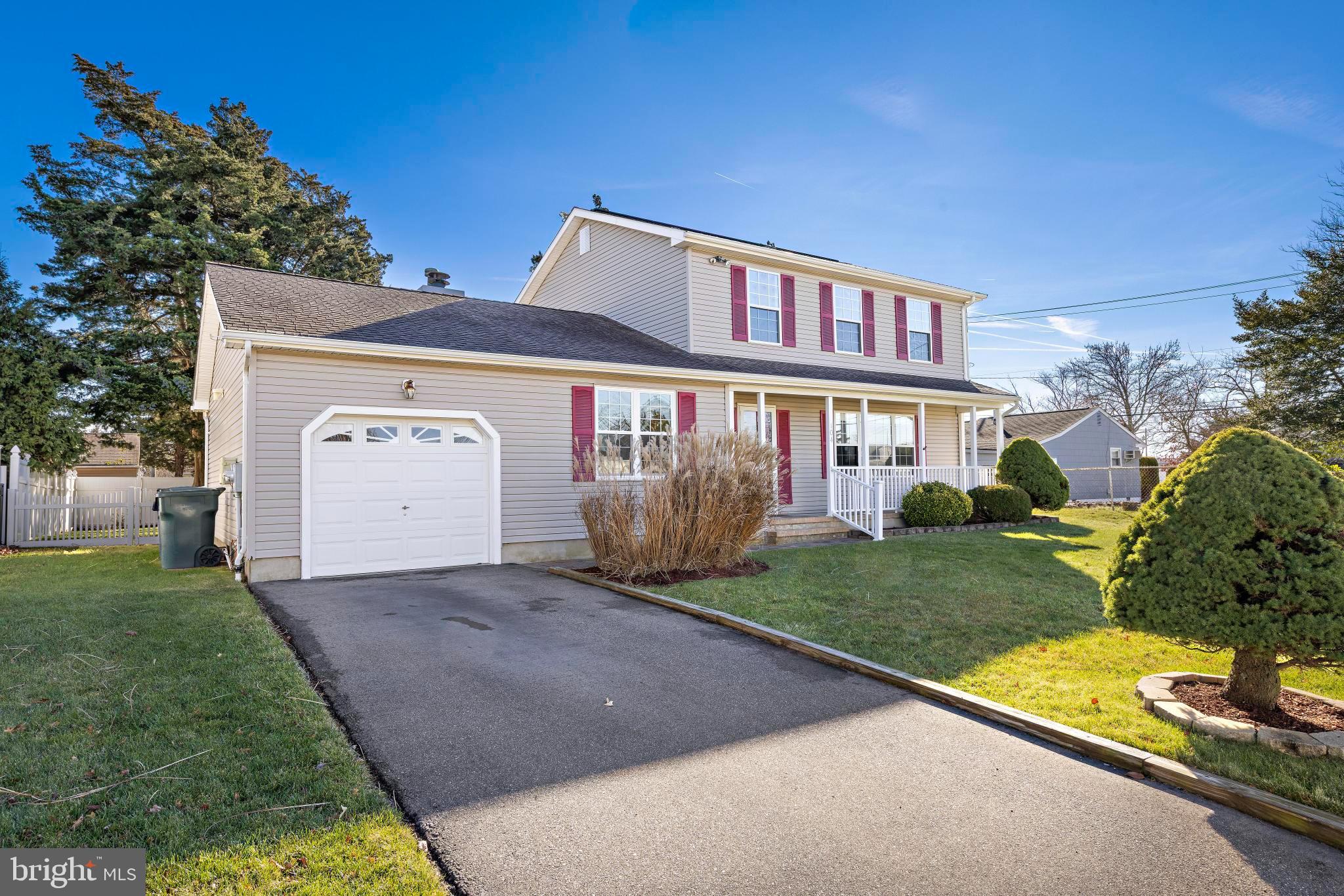 104 Greenwood Lake Road Little Egg Harbor, NJ 08087 - Photo 4 of 43 a front view of a house with a yard and garage