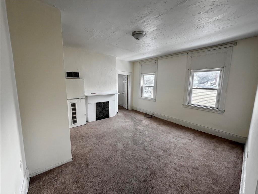 3027 Stayton Street Pittsburgh, PA 15212 - Photo 14 of 17 an empty room with windows and fireplace