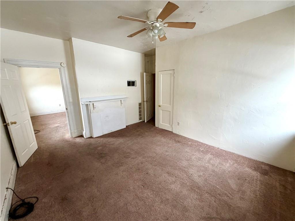 3027 Stayton Street Pittsburgh, PA 15212 - Photo 16 of 17 an empty room with a empty space and a ceiling fan window