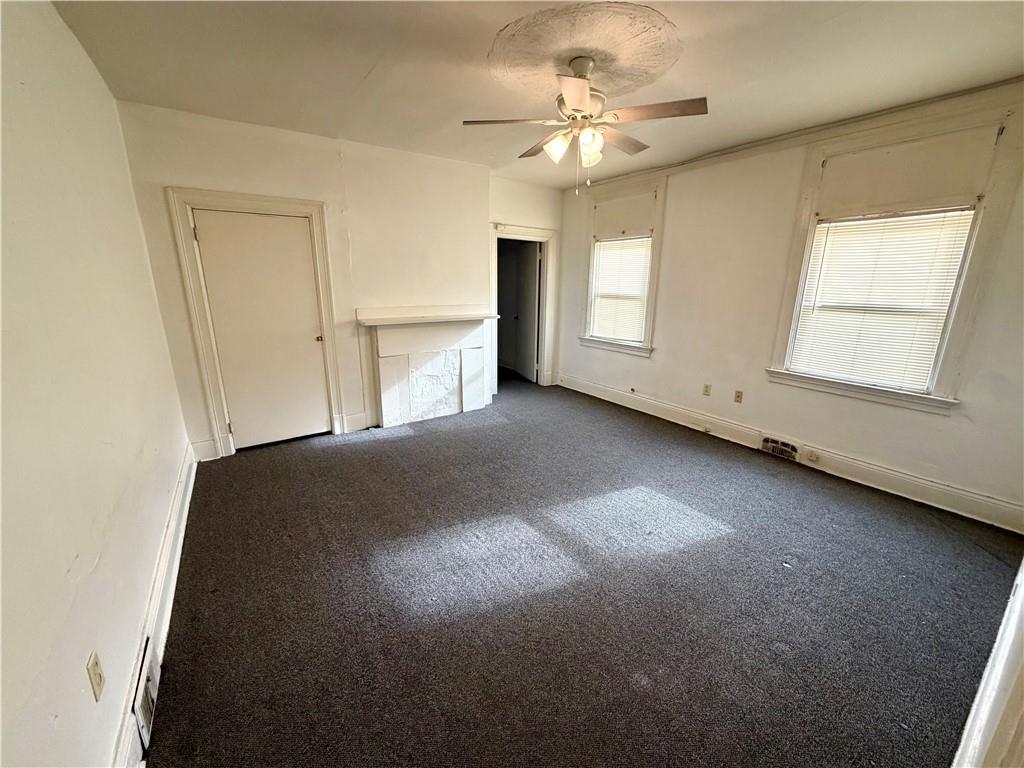 3027 Stayton Street Pittsburgh, PA 15212 - Photo 5 of 17 an empty room with windows and fan