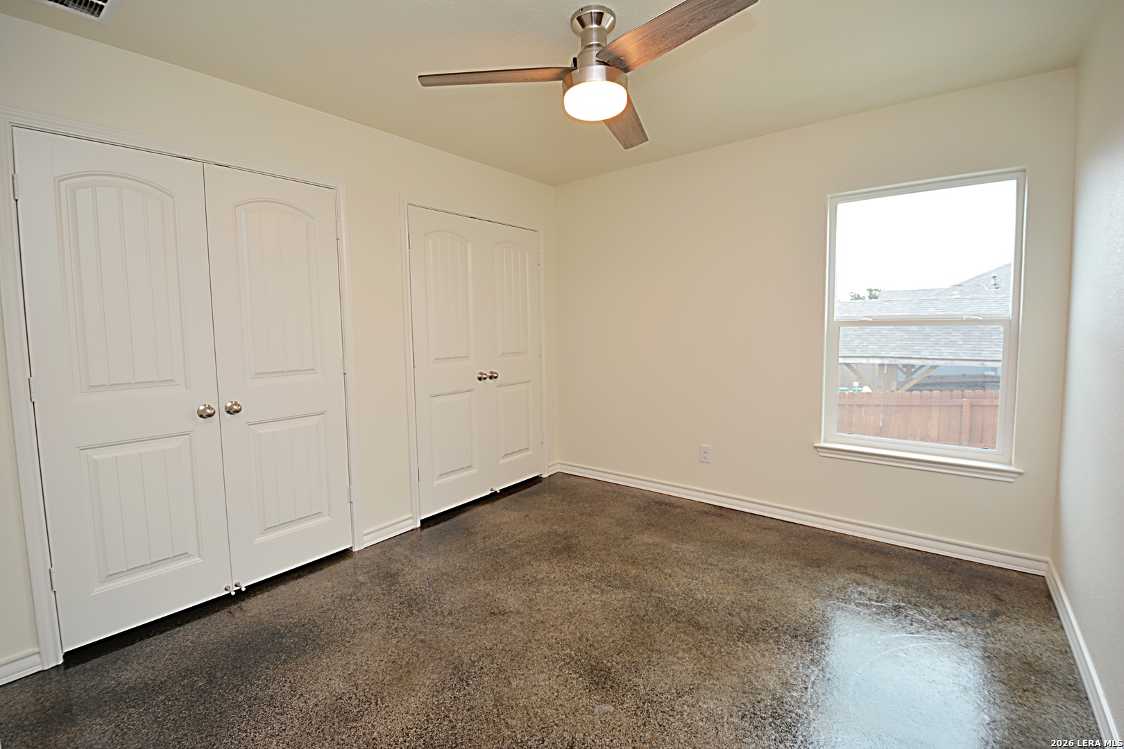 1559 Golf Course Drive Spring Branch, TX 78070 - Photo 12 of 15 an empty room with windows and fan