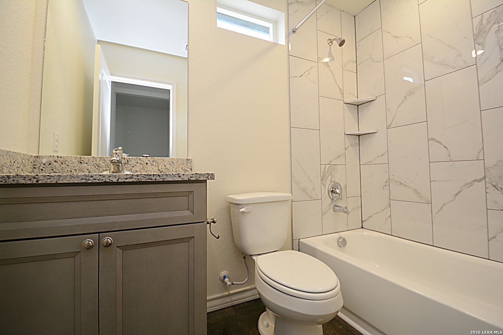 1559 Golf Course Drive Spring Branch, TX 78070 - Photo 13 of 15 a bathroom with a granite countertop toilet sink and mirror